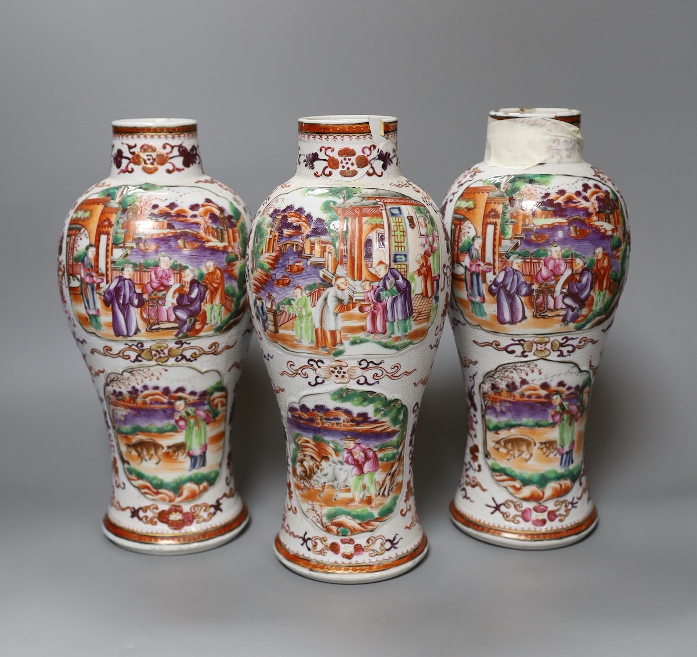 A set of three Qianlong famille rose baluster vases, 24.5cm tall